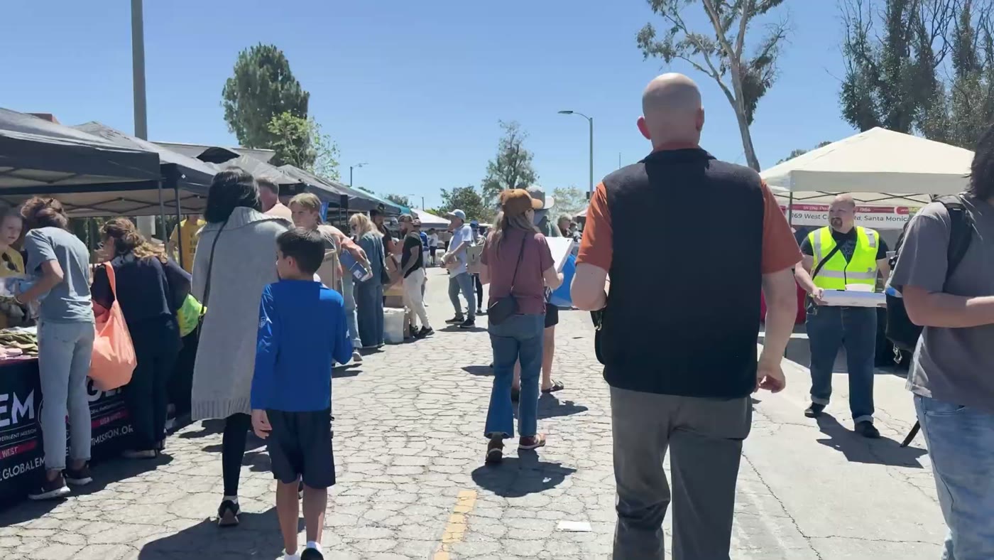 Families and volunteers outside the Pali Hub on opening day